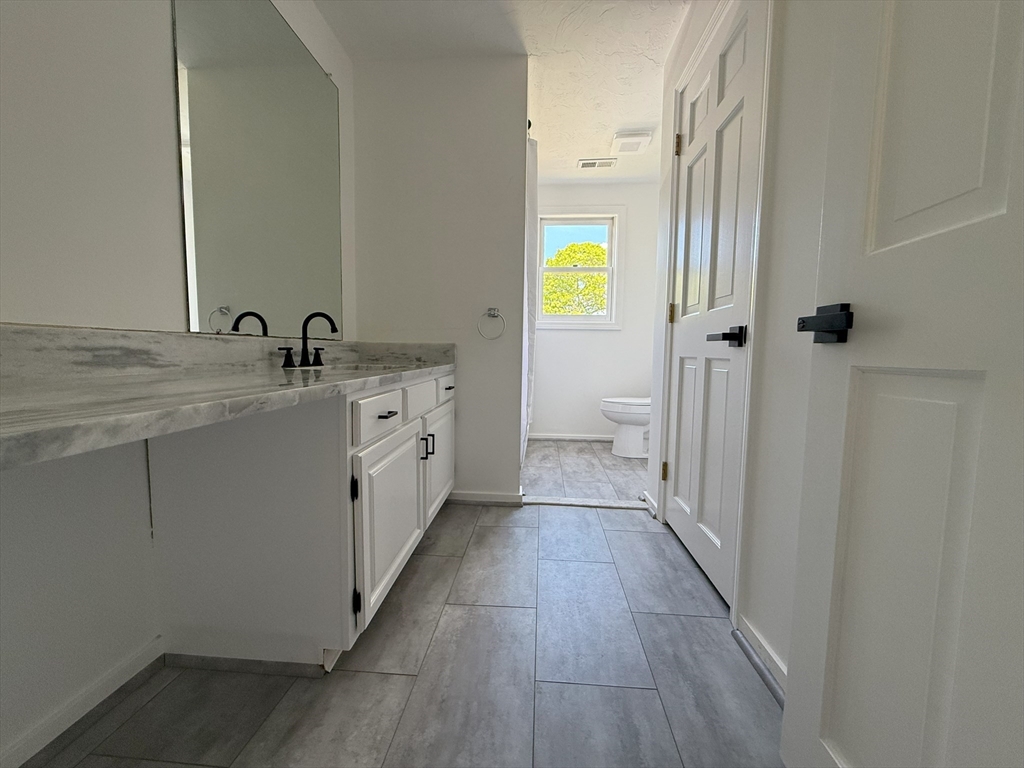 51 A Minot Avenue, Unit 1 Wareham, MA 02571 - Photo 20 of 26 a view of a bathroom with a sink and a mirror