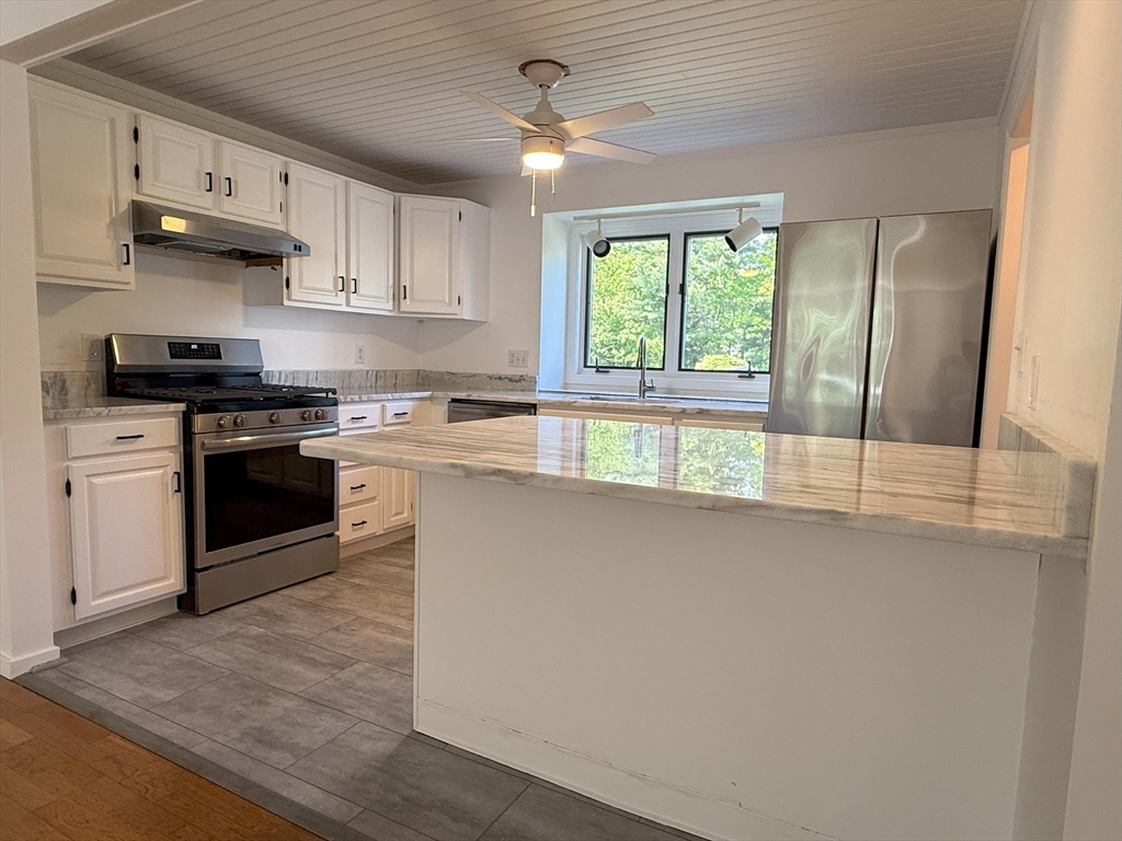51 A Minot Avenue, Unit 1 Wareham, MA 02571 - Photo 2 of 26 a kitchen with stainless steel appliances a stove sink and cabinets
