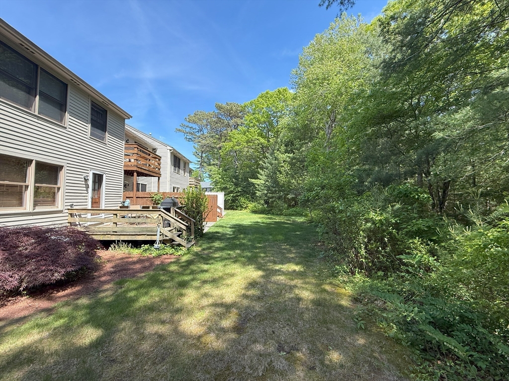 51 A Minot Avenue, Unit 1 Wareham, MA 02571 - Photo 24 of 26 a backyard of a house with table and chairs