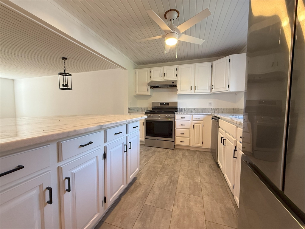 51 A Minot Avenue, Unit 1 Wareham, MA 02571 - Photo 5 of 26 a kitchen with granite countertop white cabinets and white appliances