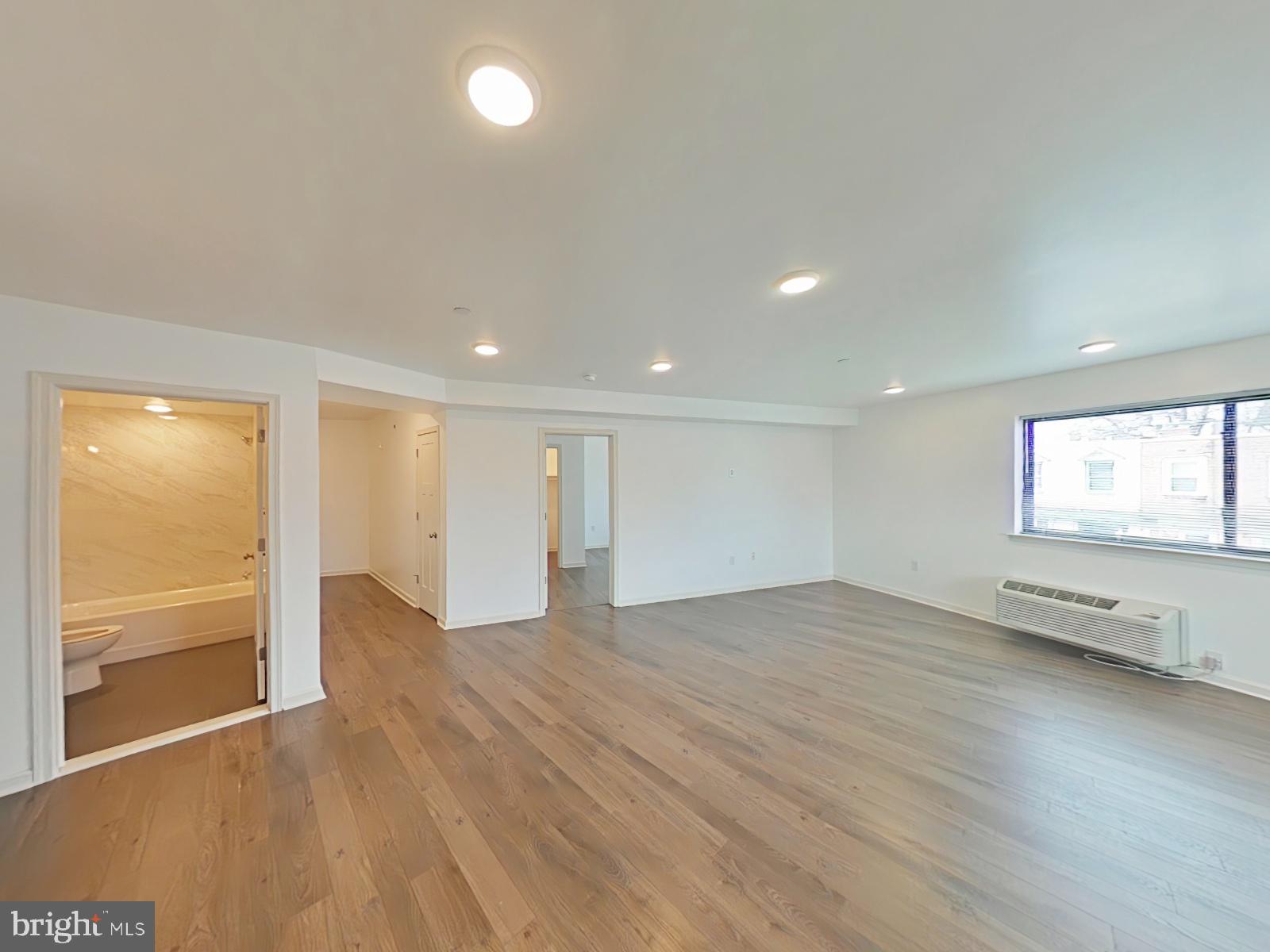 5420 Ridge Avenue, Unit 409 Philadelphia, PA 19128 - Photo 1 of 13 an empty room with wooden floor and windows