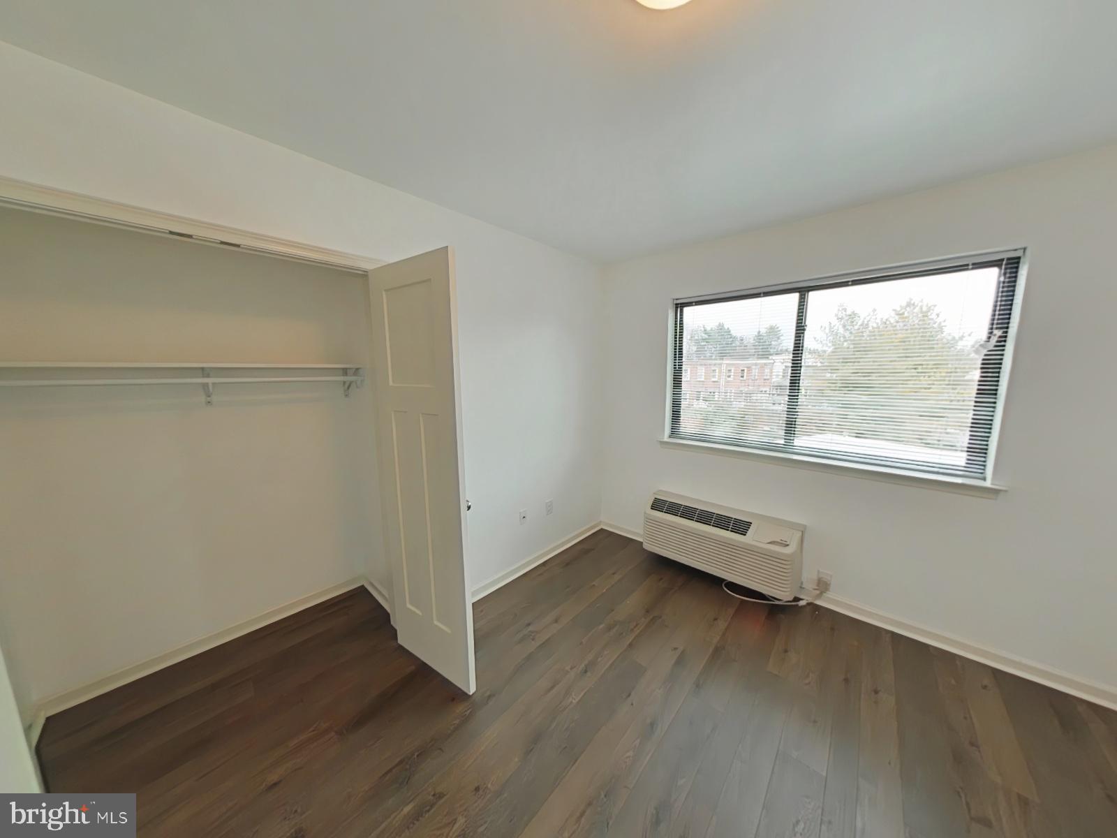5420 Ridge Avenue, Unit 409 Philadelphia, PA 19128 - Photo 8 of 13 an empty room with wooden floor and windows