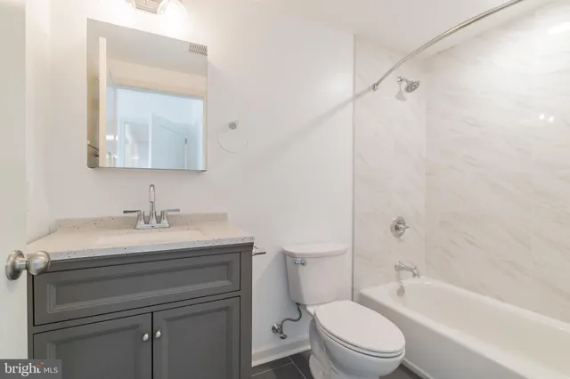 a bathroom with a sink toilet vanity and shower