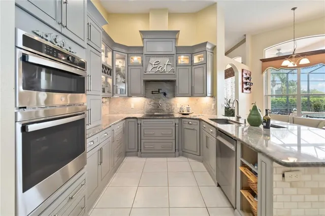 a kitchen with stainless steel appliances granite countertop a stove and cabinets