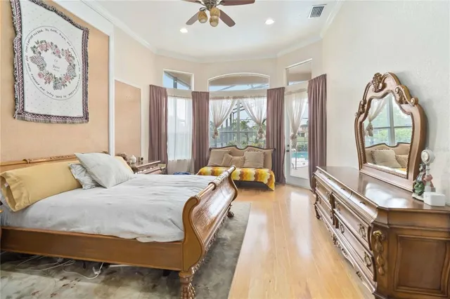 a spacious bedroom with a bed a couch and a large window