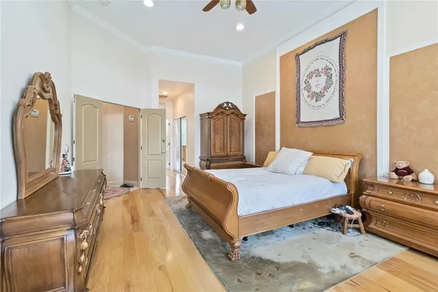 a spacious bedroom with a bed a dresser and couch