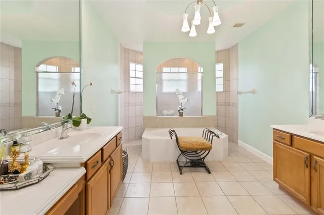 a spacious bathroom with a granite countertop sink a toilet mirror and a bathtub