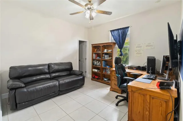 a view of a livingroom with workspace and a couch