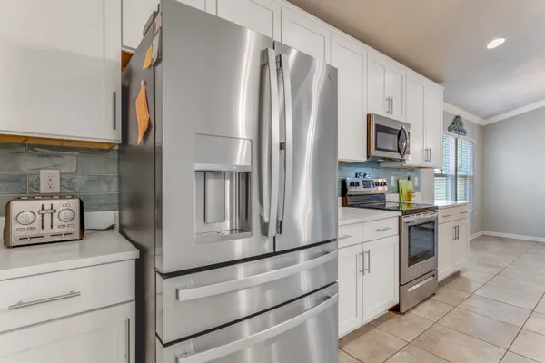 a kitchen with stainless steel appliances a refrigerator stove and microwave