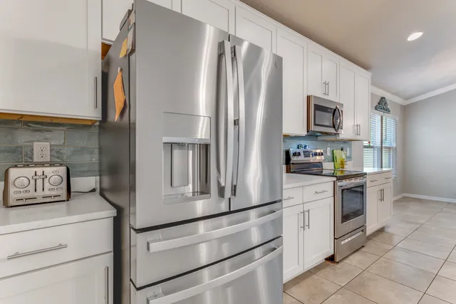 a kitchen with stainless steel appliances a refrigerator stove and microwave