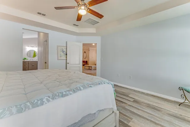 a bedroom with a bed and a chandelier