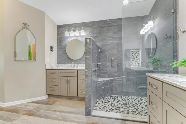 a bathroom with a sink a mirror and a shower