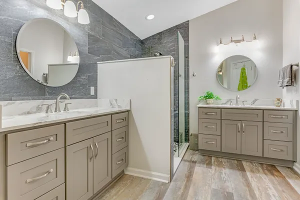 a spacious bathroom with a double vanity sink and a mirror