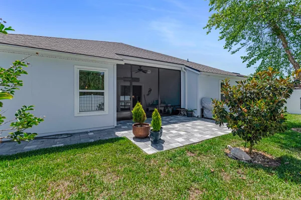 a view of a backyard with a table and chairs and potted plants