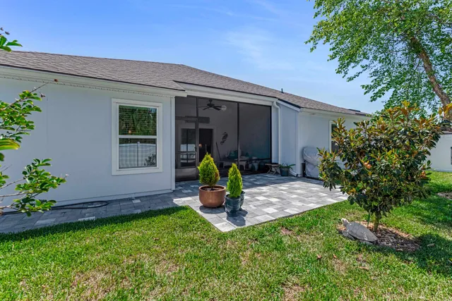 a view of a backyard with a table and chairs and potted plants