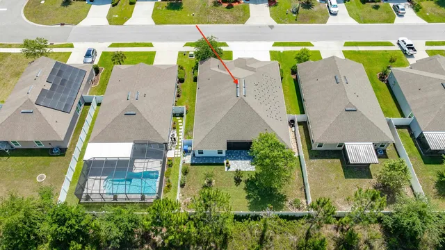 an aerial view of residential houses with outdoor space and swimming pool