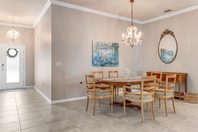 a view of a dining room with furniture and chandelier
