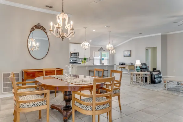 a view of a dining room with furniture and chandelier