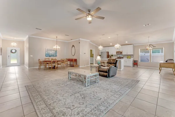 a living room with furniture and a view of kitchen