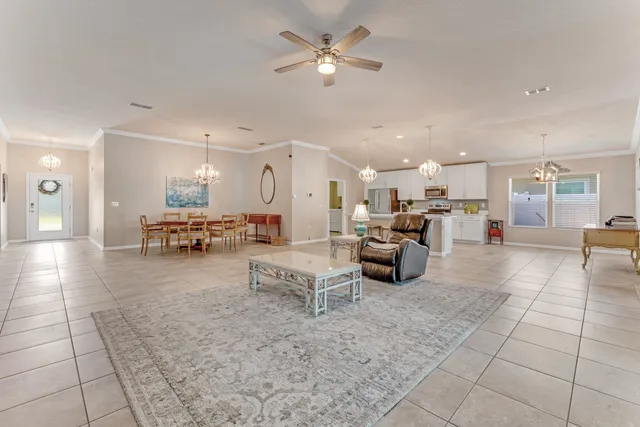 a living room with furniture and a view of kitchen