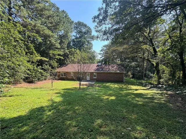 a view of a backyard with swimming pool