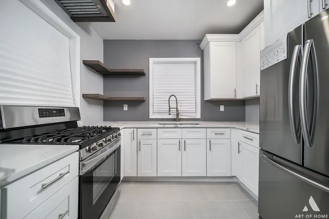a kitchen with granite countertop a sink stove and refrigerator