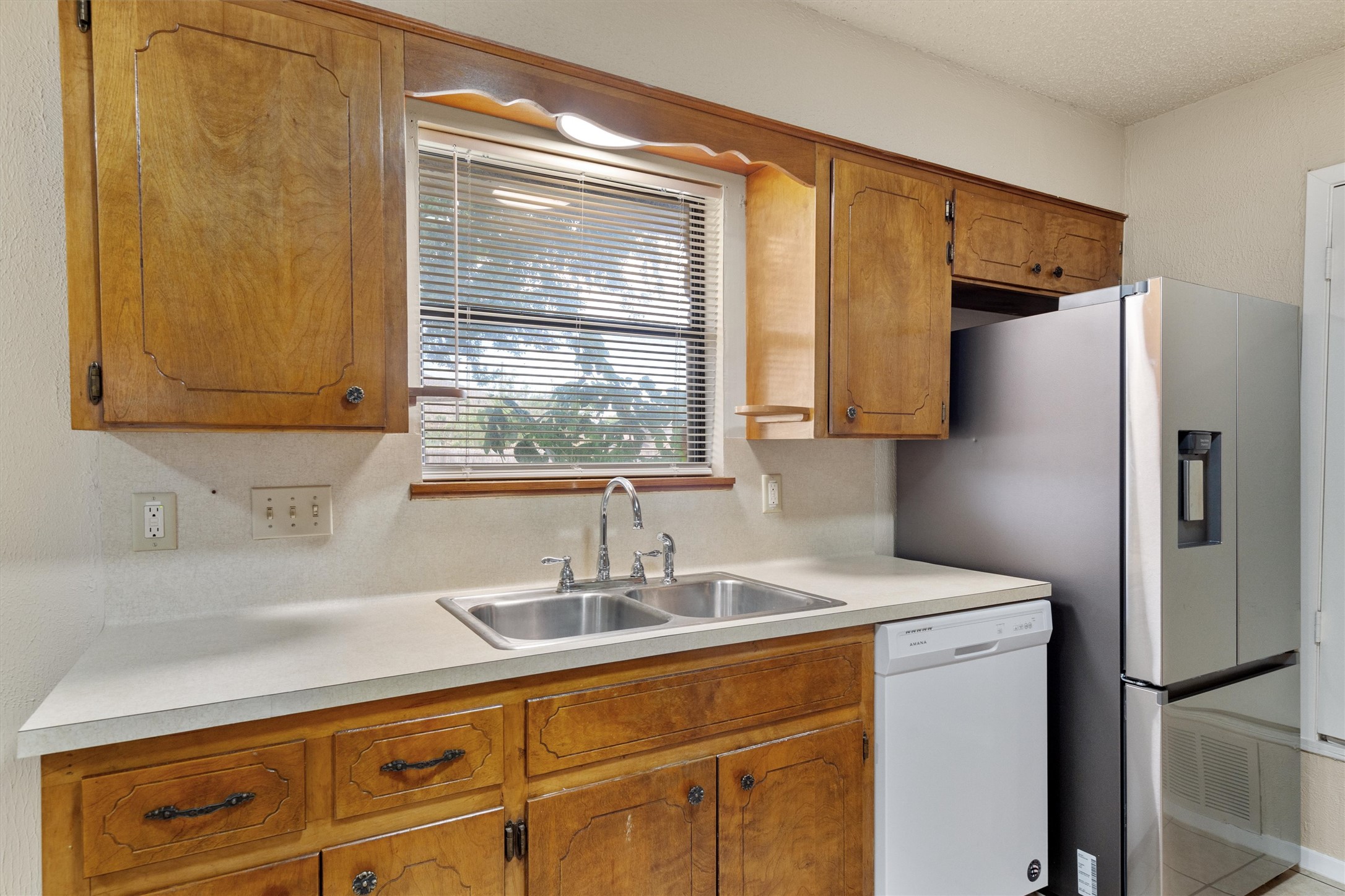 2805 Davis Street, Unit A Taylor, TX 76574 - Photo 6 of 12 a kitchen with stainless steel appliances a sink and a refrigerator
