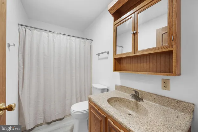 a view of balcony with wooden floor and fence