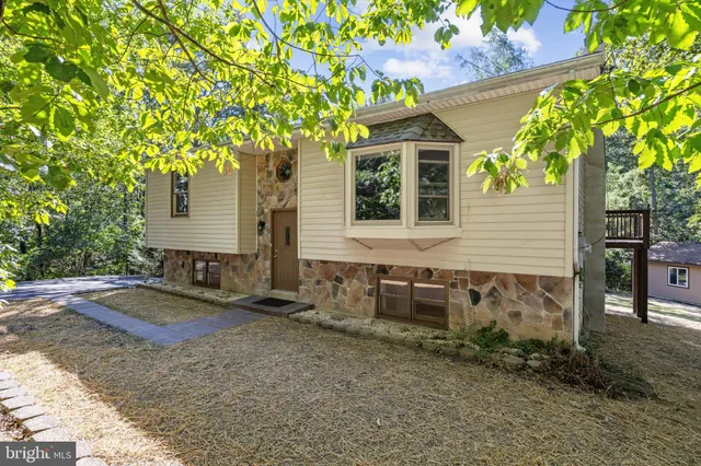 a view of staircase with railing and white walls