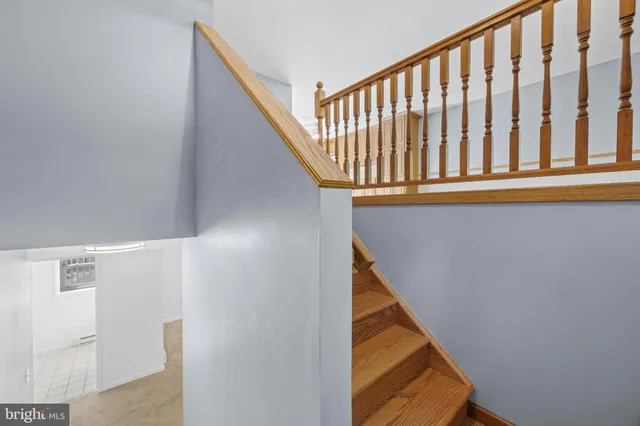 a kitchen with stainless steel appliances granite countertop a refrigerator a sink and dishwasher with wooden floor