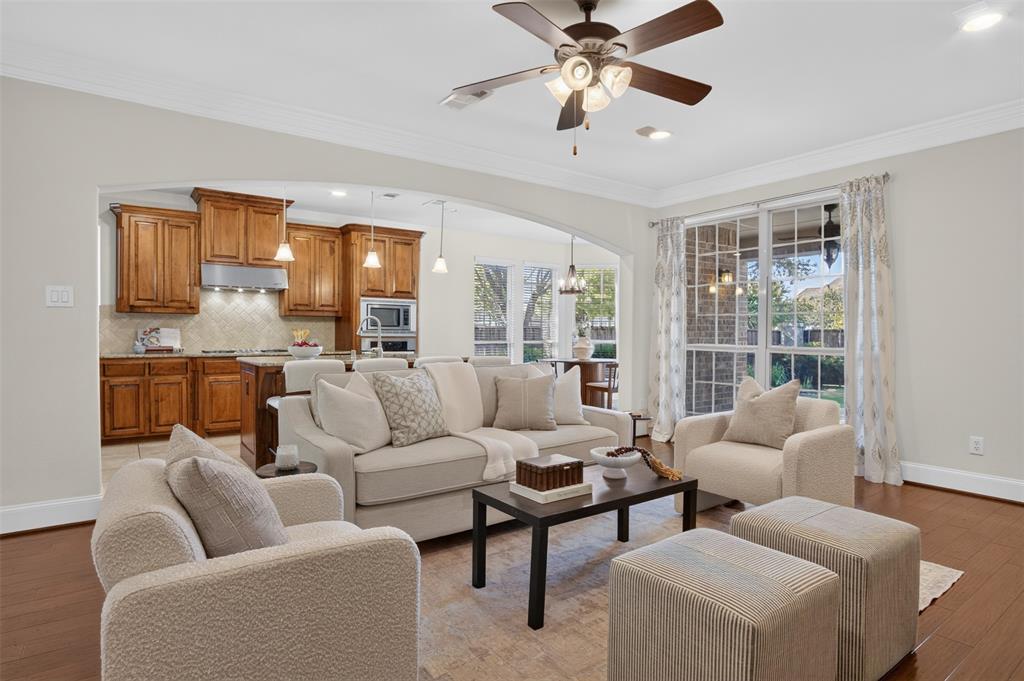 842 Sun Meadow Road Allen, TX 75013 - Photo 1 of 39 Open-concept living area featuring wood-finish flooring, recessed lighting, and a ceiling fan