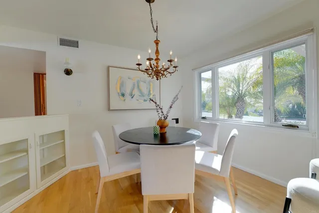 a large kitchen with cabinets wooden floor and stainless steel appliances