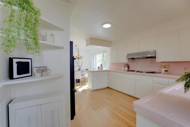 a kitchen with stainless steel appliances a refrigerator and a stove top oven