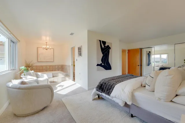 a bedroom with a bed and a couch