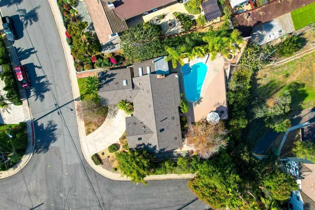 an aerial view of a house with a yard and garden