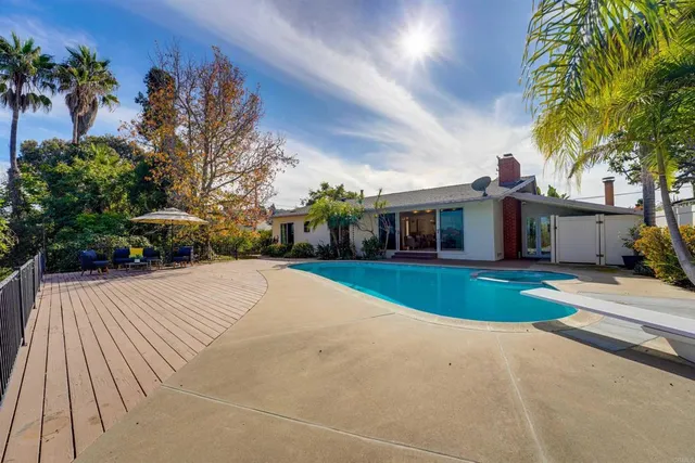 a view of a patio with table and chairs potted plants and large tree