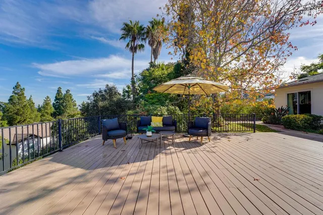 a view of a backyard with sitting area