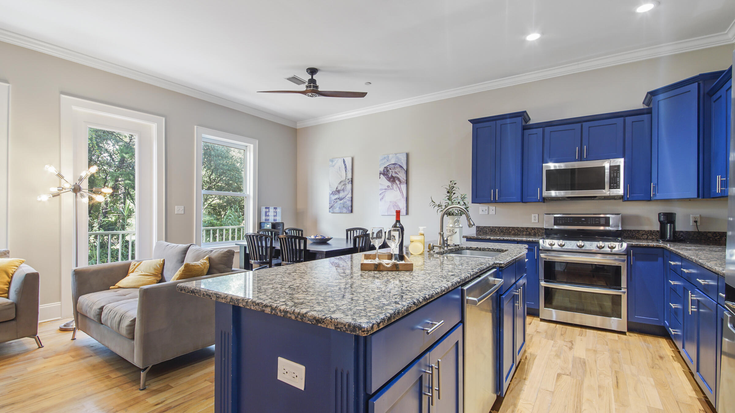 a kitchen with granite countertop kitchen island stainless steel appliances a sink stove and cabinets