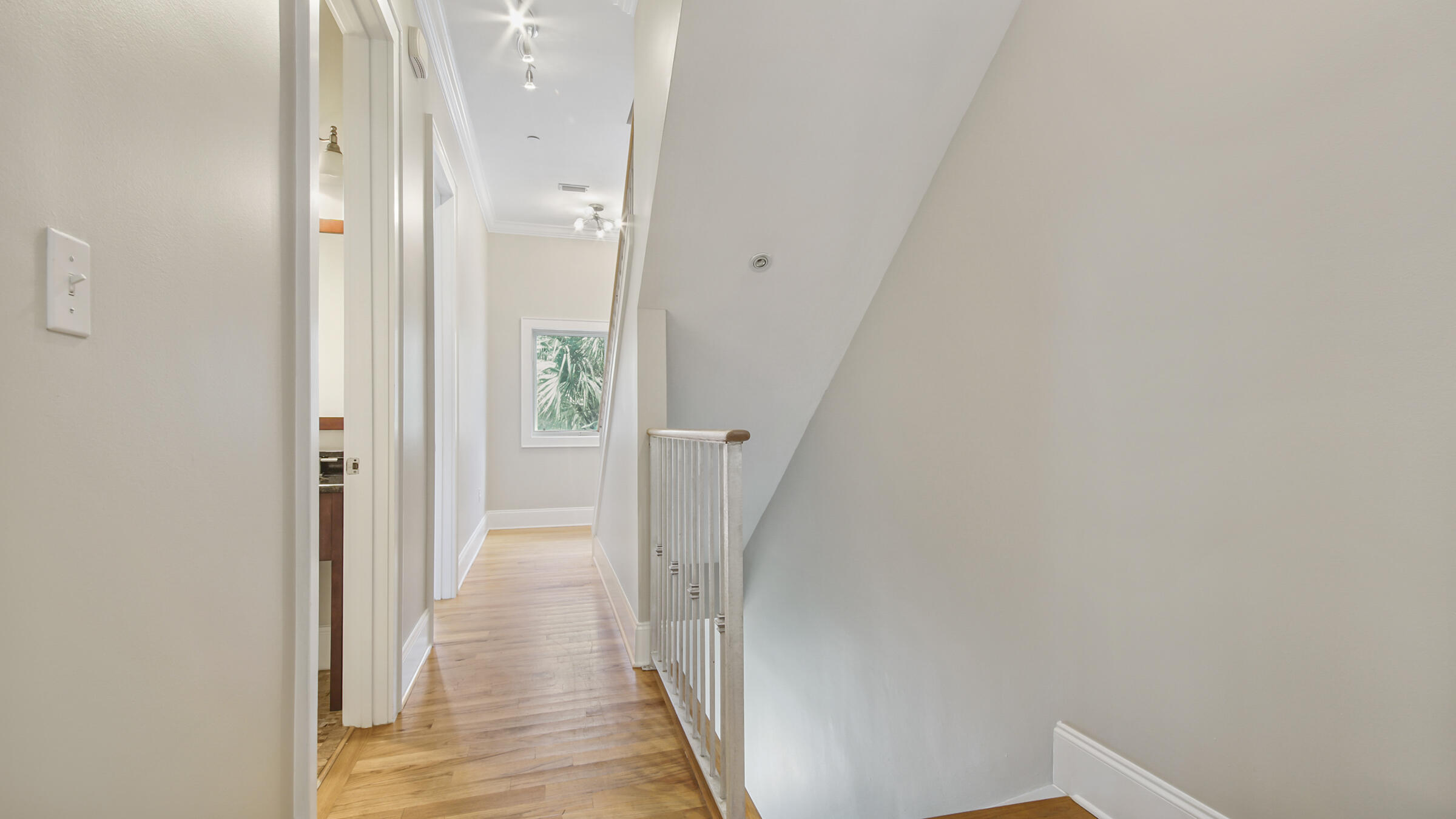 43 Coastal Grove Way, Unit 5 Santa Rosa Beach, FL 32459 - Photo 21 of 56 a view of a hallway with wooden floor and a bathroom