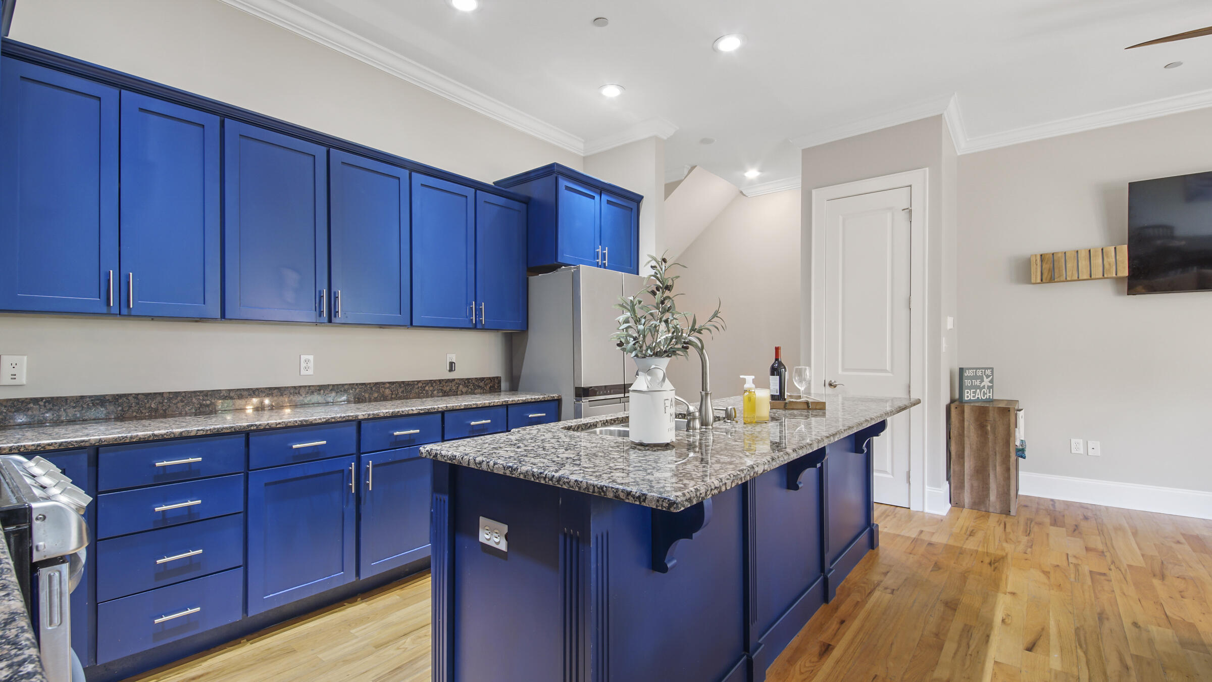 43 Coastal Grove Way, Unit 5 Santa Rosa Beach, FL 32459 - Photo 25 of 56 a kitchen with kitchen island granite countertop wooden cabinets a sink and dishwasher