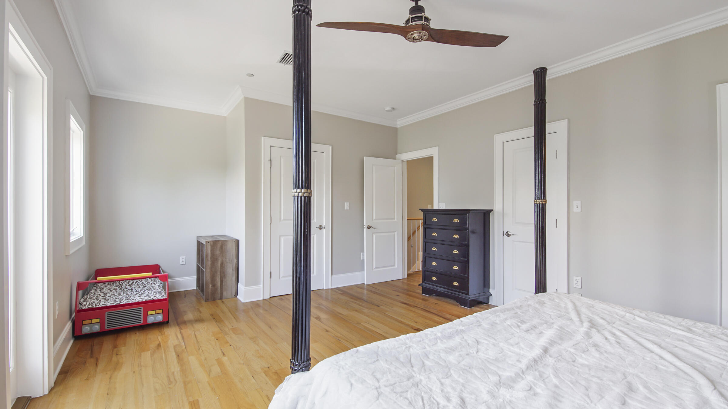 43 Coastal Grove Way, Unit 5 Santa Rosa Beach, FL 32459 - Photo 38 of 56 a bedroom with a bed and wooden floor