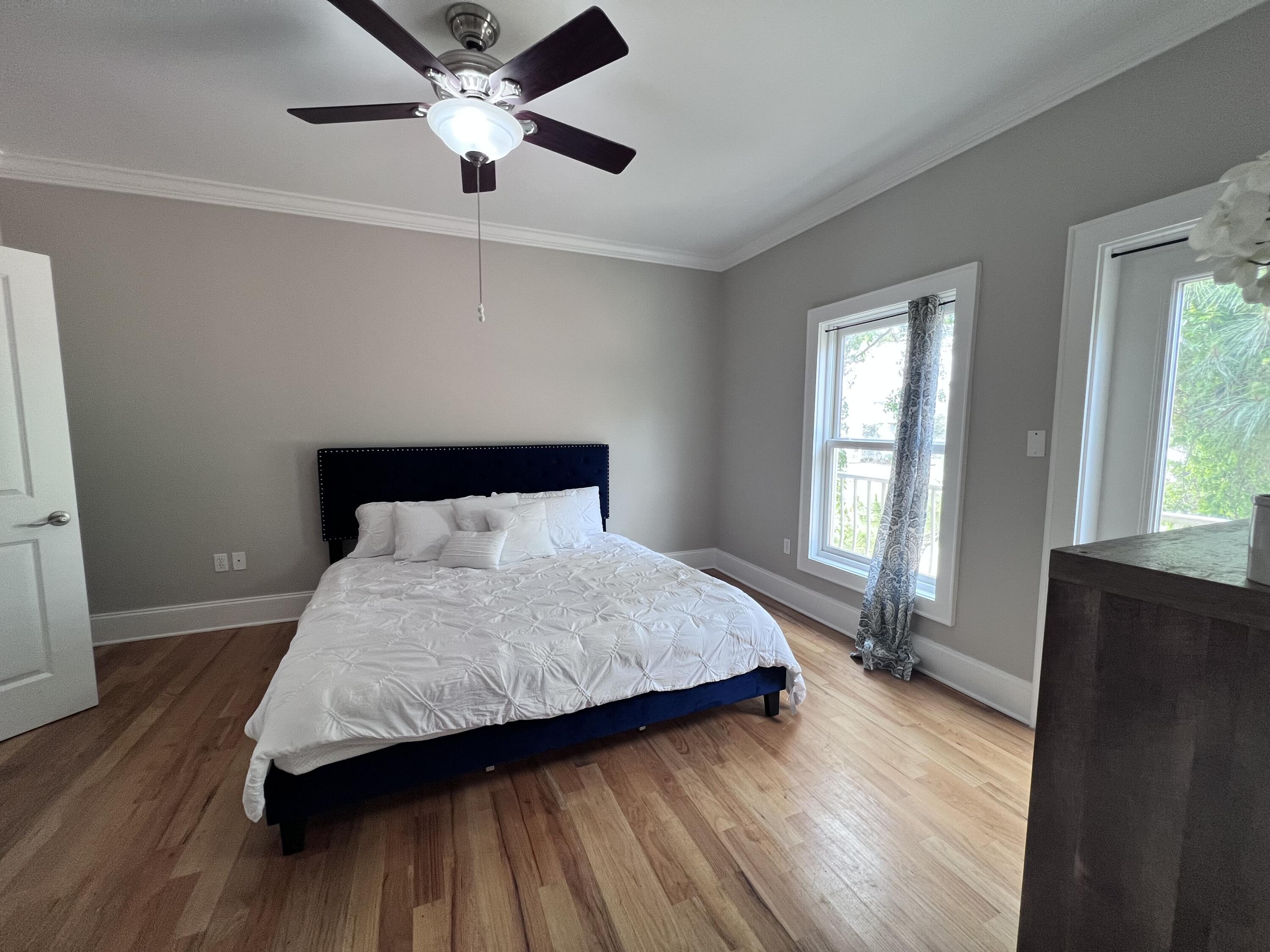 43 Coastal Grove Way, Unit 5 Santa Rosa Beach, FL 32459 - Photo 42 of 56 a bedroom with a bed and wooden floor