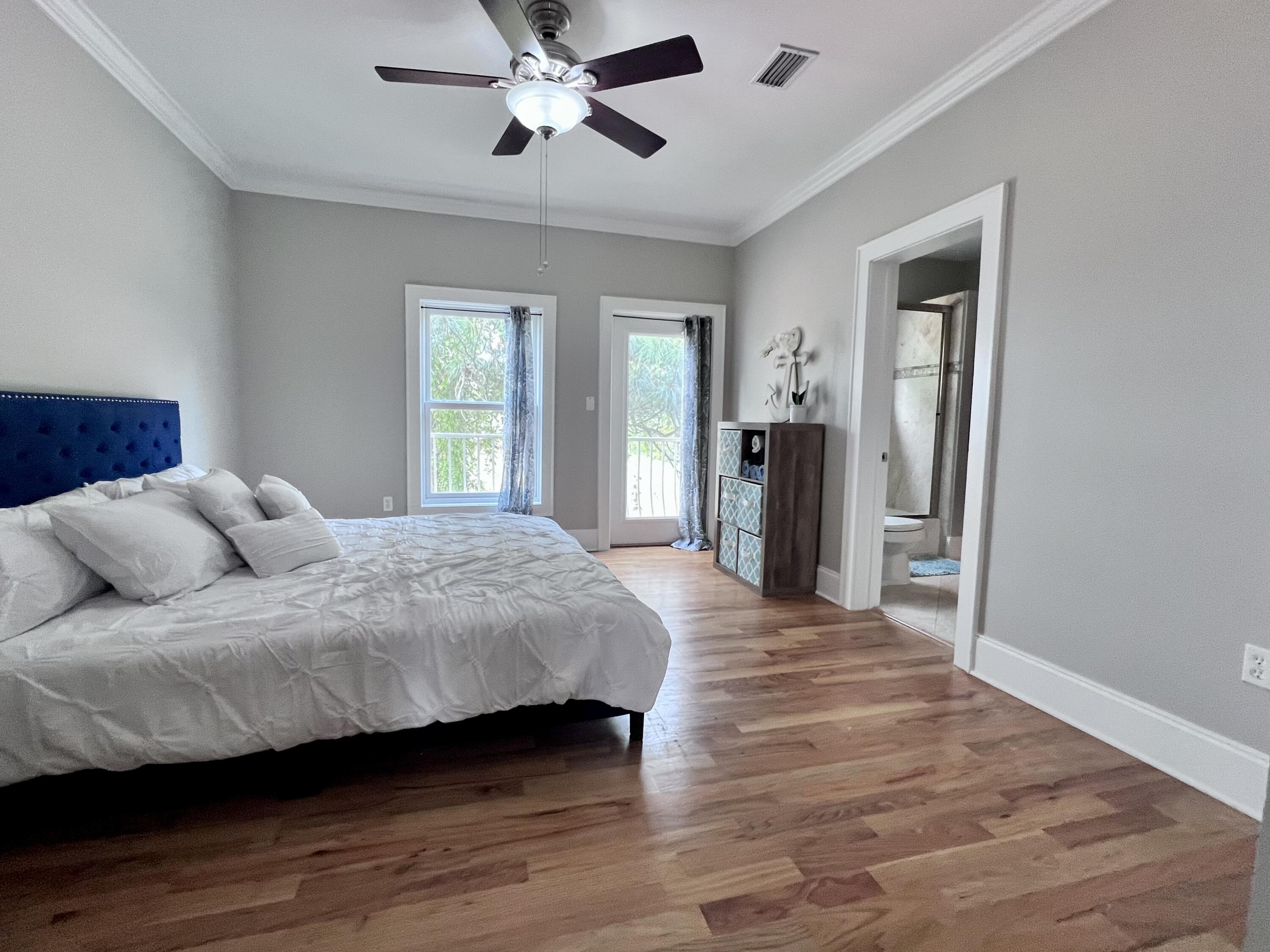 43 Coastal Grove Way, Unit 5 Santa Rosa Beach, FL 32459 - Photo 43 of 56 a spacious bedroom with a bed and a chandelier