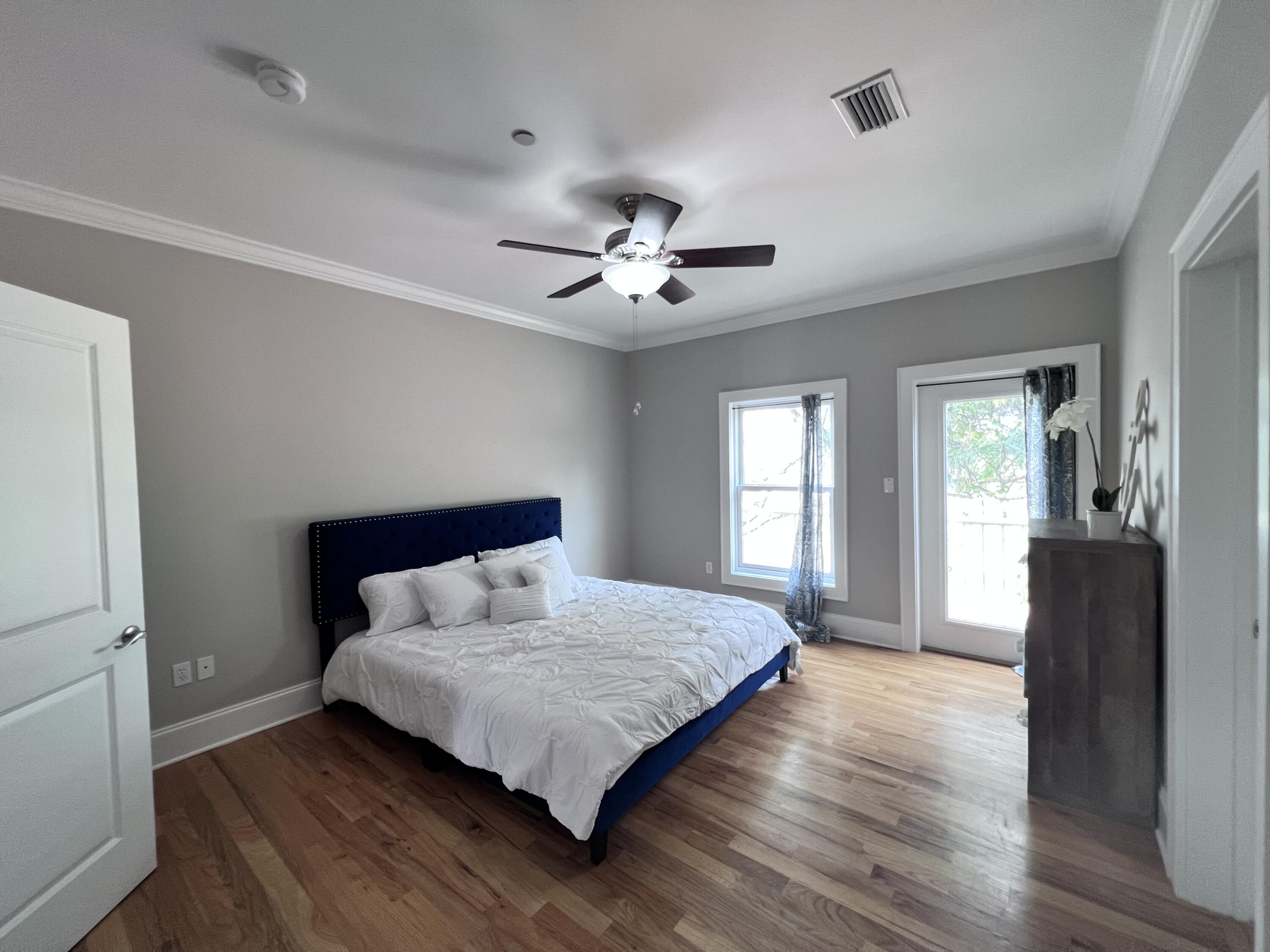 43 Coastal Grove Way, Unit 5 Santa Rosa Beach, FL 32459 - Photo 44 of 56 a bedroom with a bed and wooden floor