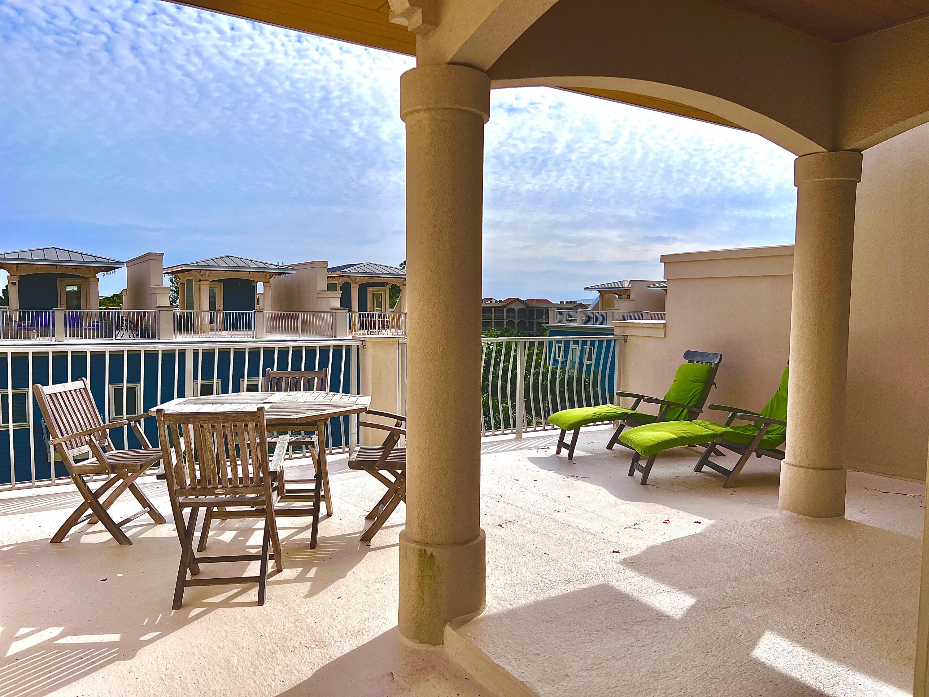 43 Coastal Grove Way, Unit 5 Santa Rosa Beach, FL 32459 - Photo 48 of 56 a view of a chair and table in the balcony