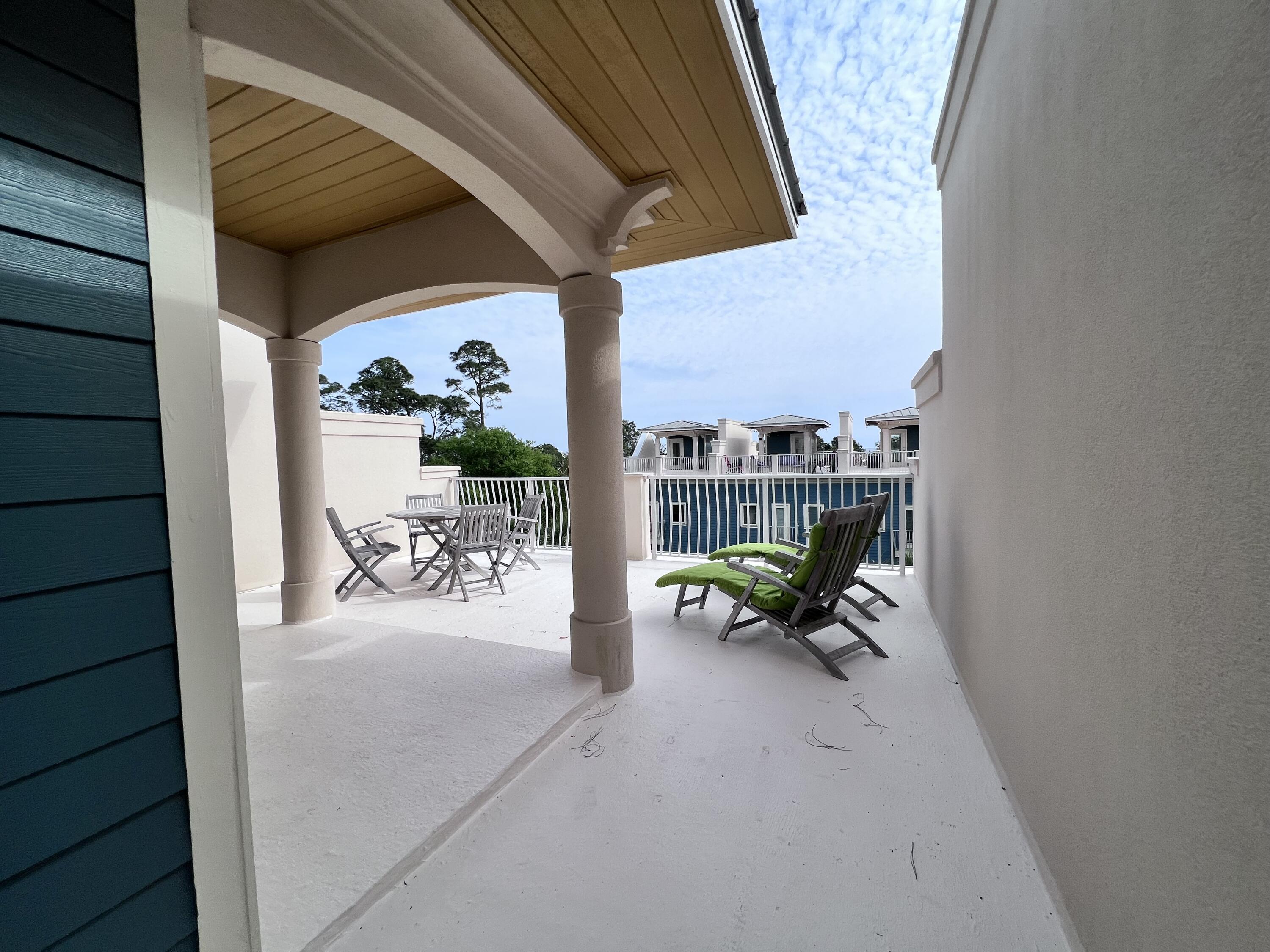 43 Coastal Grove Way, Unit 5 Santa Rosa Beach, FL 32459 - Photo 50 of 56 a view of a patio with table and chairs and potted plants