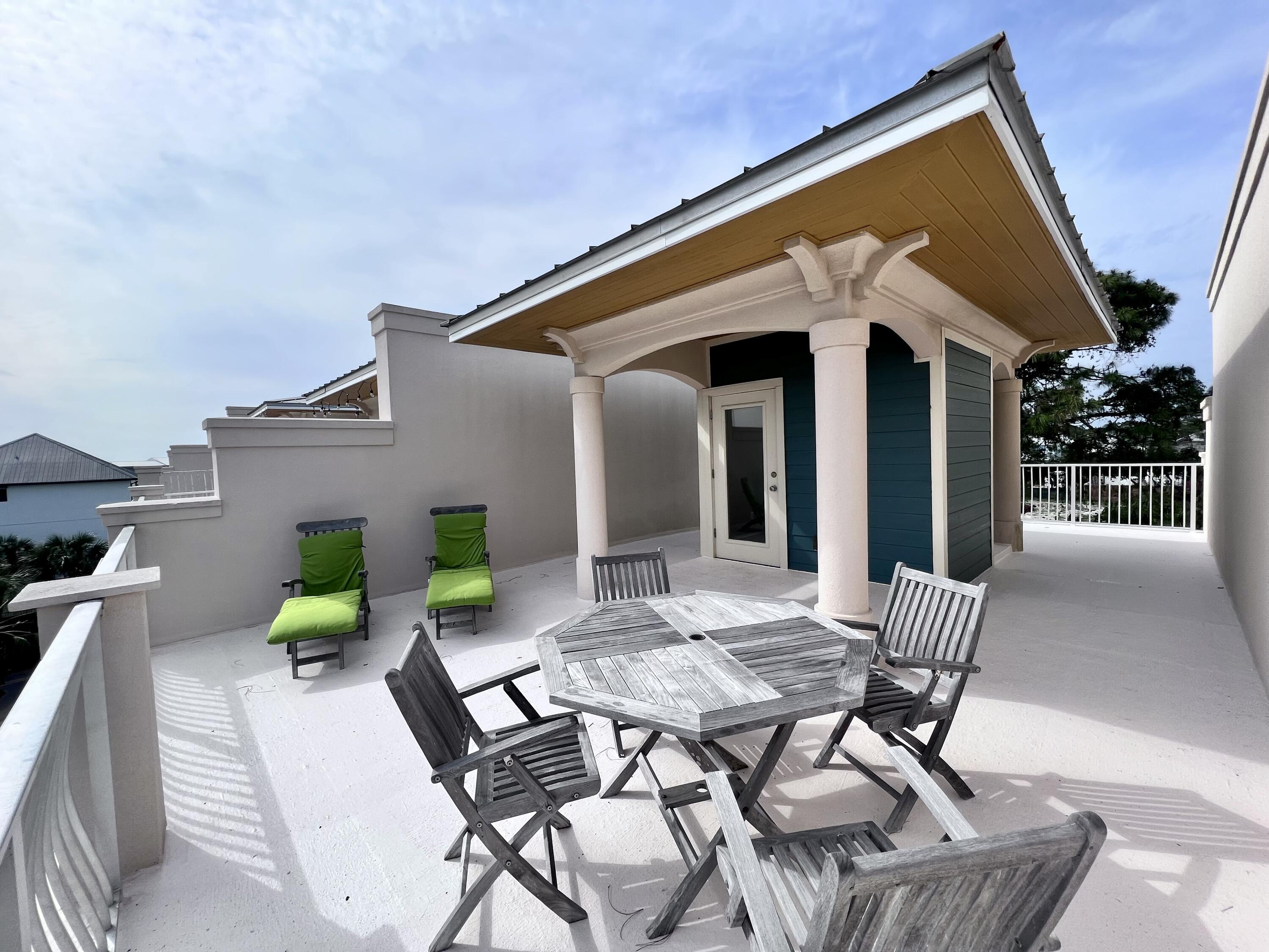 43 Coastal Grove Way, Unit 5 Santa Rosa Beach, FL 32459 - Photo 53 of 56 a view of a patio with table and chairs and potted plants