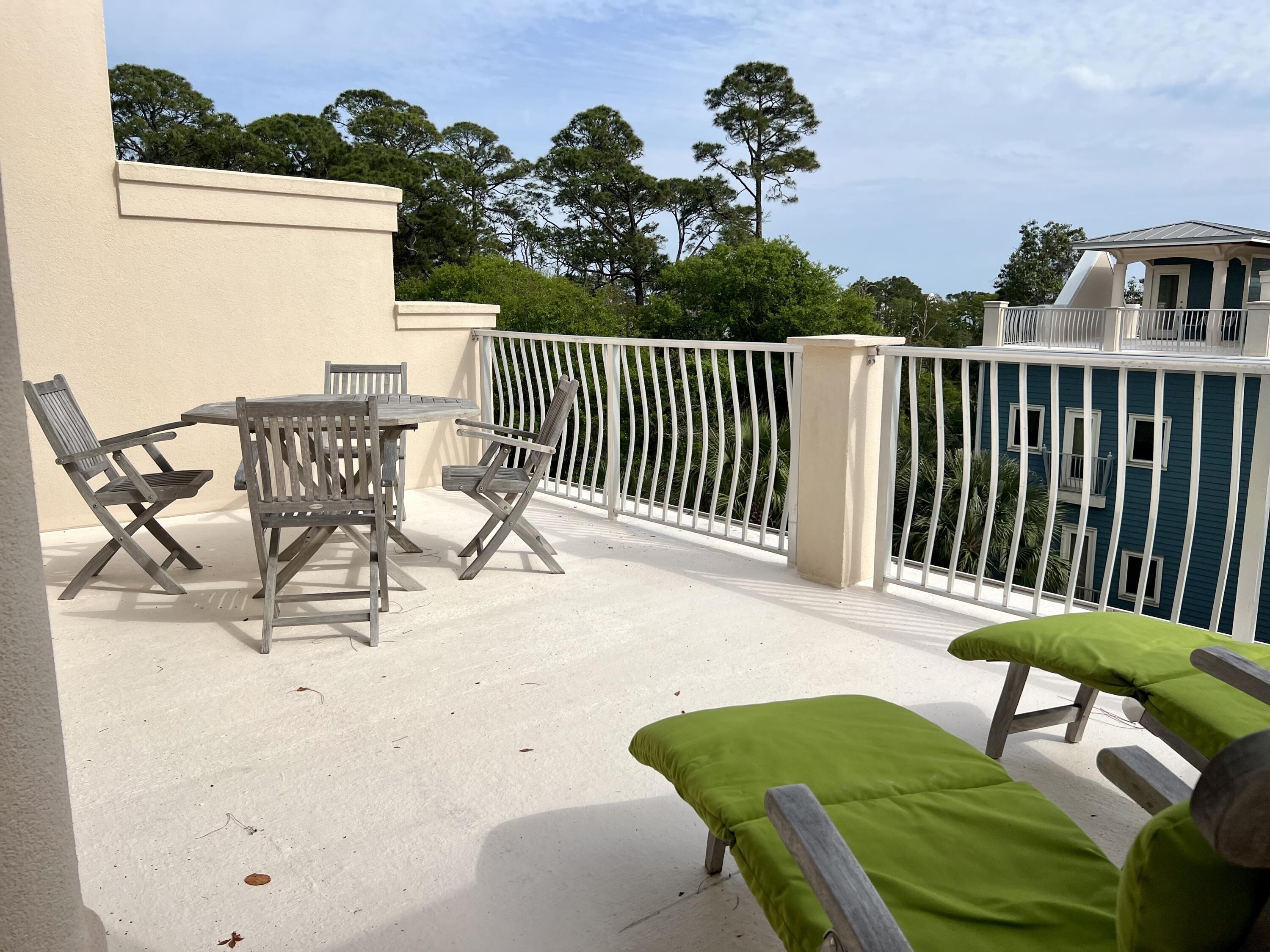 43 Coastal Grove Way, Unit 5 Santa Rosa Beach, FL 32459 - Photo 55 of 56 a view of a chairs and table in patio