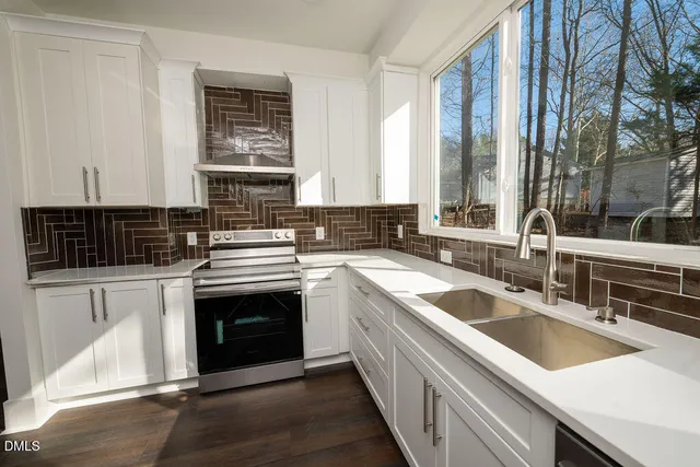 a kitchen that has a sink and a stove