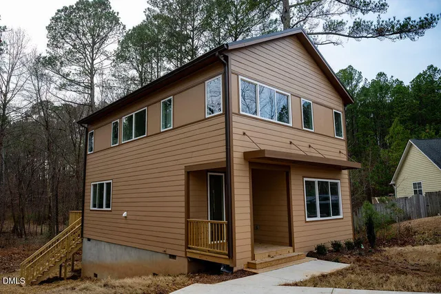 a view of a house with a large tree